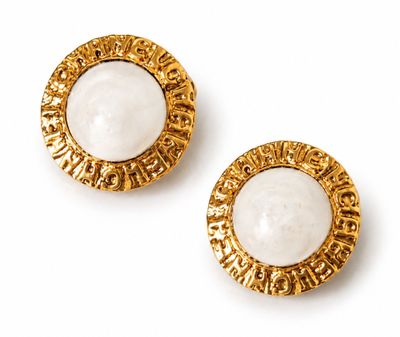 an image of a pair of white and gold earrings