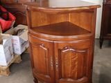 a small corner cabinet in the middle of a room