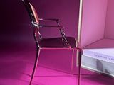 a chair that is next to a bed in a room