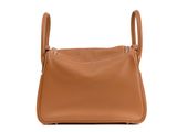 a brown leather shoulder bag on a white background