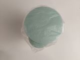a blue cake on a white table with a plastic bag