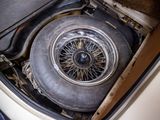 a car that has a tire in the trunk of it