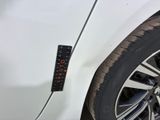 a close up of a car ' s tire with a clock on it