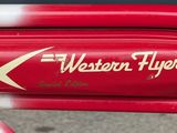 a close up of a red bike with a sign on it