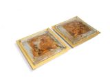 two trays of food sitting on top of each other