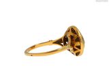 a close up of a gold ring with a diamond in the center