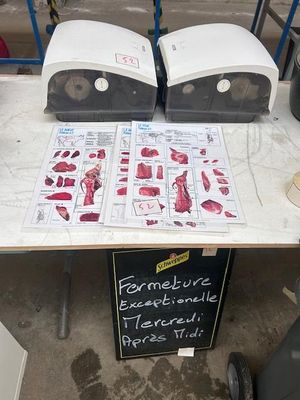 two pizza ovens sitting on a table with a sign