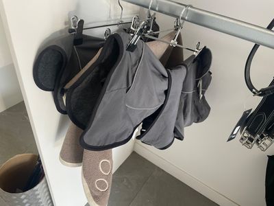 a coat rack with several pairs of shoes hanging on it