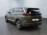 the rear end of a dark colored suv parked in a room