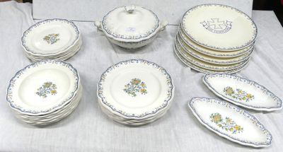 many plates and bowls on a table with a white table cloth