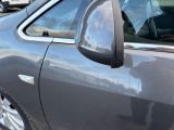 a dog sitting in the passenger seat of a car