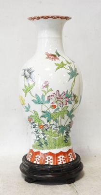 a white vase with a red and green design on it