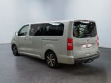 the rear of a silver van parked in a large room
