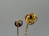 gold plated flower brooch with a knot on the stem