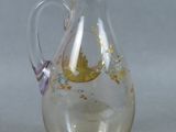 a glass pitcher with a floral design on it