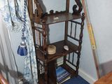 a wooden shelf with a mirror on it next to a chair