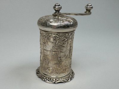 un moulin à café ancien en argent sur fond blanc