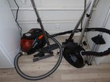 two vacuums that are sitting on the floor next to each other