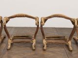 a row of wooden chairs that are sitting on a wooden floor