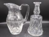 two clear glass vases sitting on a table next to each other