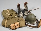 a pair of boots, a bag, and a helmet on a table