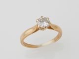 a gold ring with a white diamond on top of it