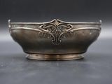 a silver bowl with a decorative design on it