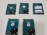 four hard drives sitting on top of each other on a table