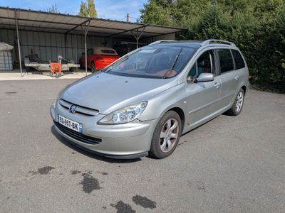 a silver car that is parked in a parking lot