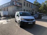 the white van is parked in front of a building on the street