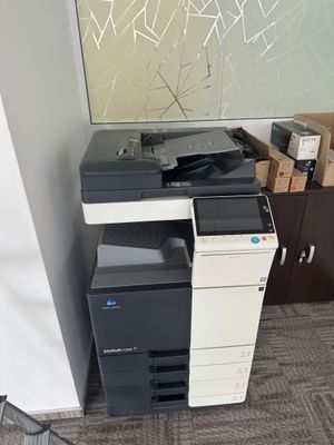 a printer sitting on top of a cabinet in a room