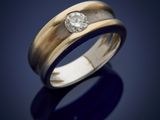 a close up of a ring with a diamond on a blue background