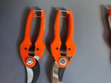 three orange pliers on display in a store