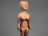 a small statue of a man standing on top of a pedestal