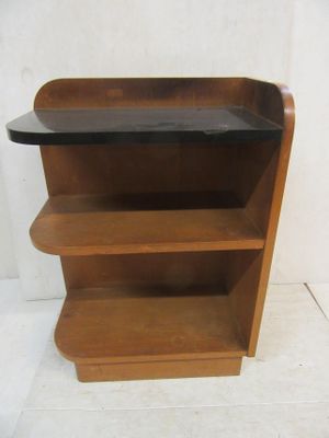 a wooden shelf with a glass top on a white floor