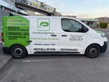 the van is parked in the parking lot next to the building