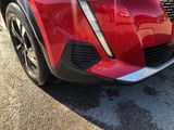 a close up of the front end of a red car