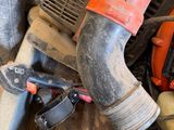 a red and black blower sitting on top of a pile of tools