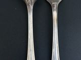 two forks that are sitting next to each other on a table