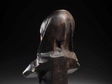 a wooden sculpture of a woman ' s head on a stand