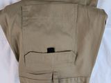 a pair of khaki pants laying on a bed
