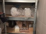 a shelf full of items in a room with tiled walls