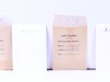 three bags of coffee sitting on top of a table next to each other