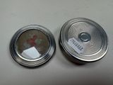 two silver tins that are sitting on a table