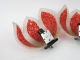 two red and white flowers that are connected to a cell phone