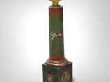 an image of a green and gold column with a white light on top