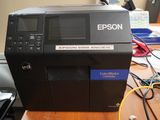 an image of a printer sitting on top of a wooden desk