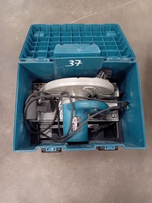 a blue box with a drill in it on the floor