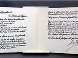 an open book with writing on it sitting on a table