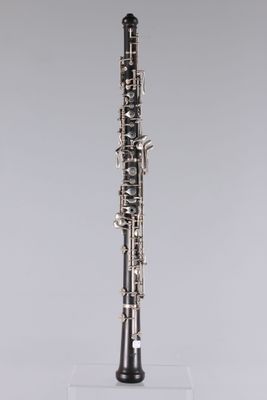 a close up of a clarinet on a clear stand